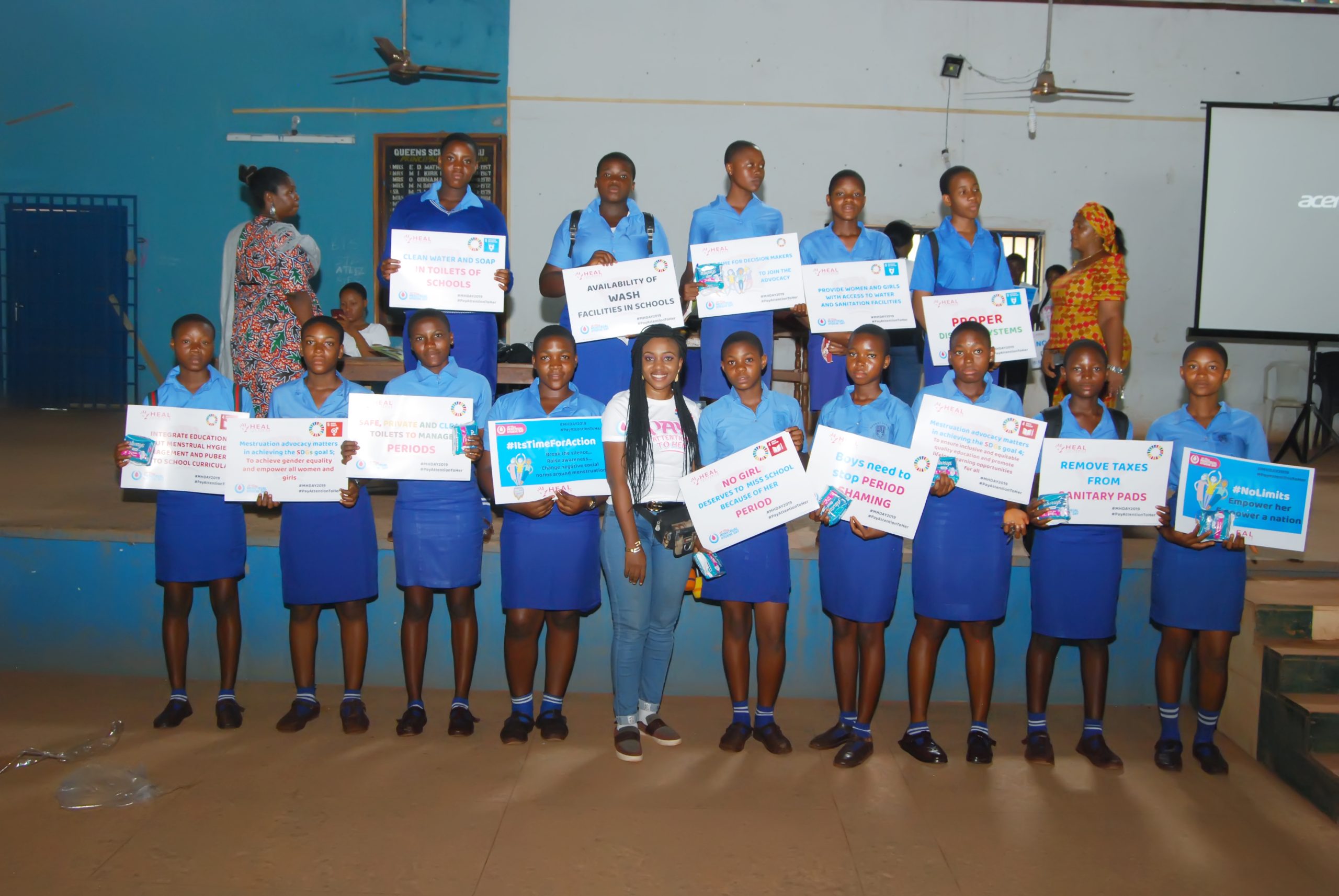 Ifunanya Dr. STM with young school girls advocating for and raising awareness on menstrual hygiene and gender equality scaled